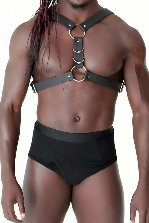 Black faux leather mens chest harness with three stacked gold O-rings and silver D-ring side adjusters