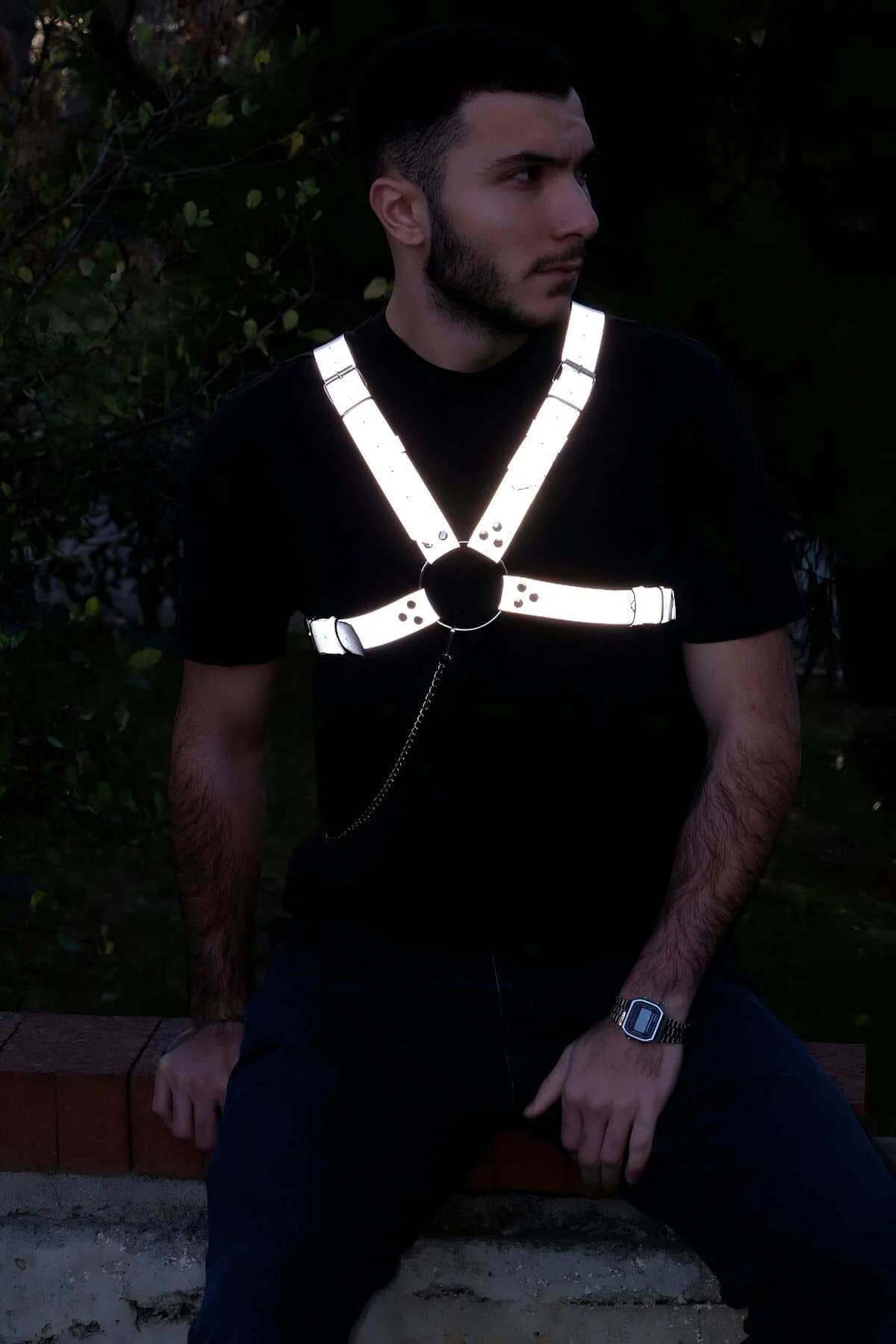 Black metal O-ring and dangling chain hardware on reflective chest harness front view