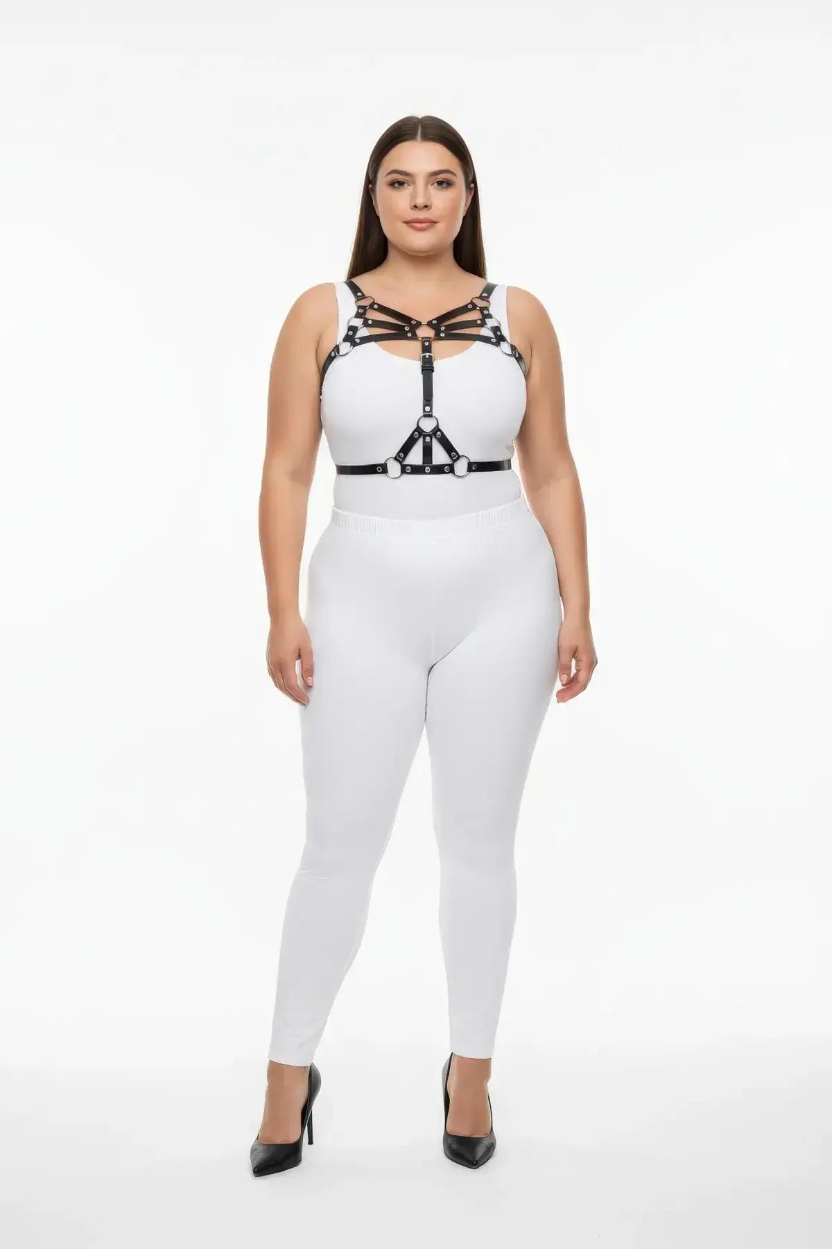 Black multi-strap chest harness with silver O-ring accents worn over white bodysuit front view