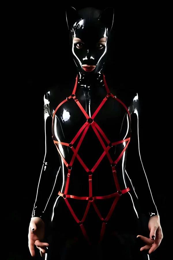 Red elastic full body harness with geometric diamond cage pattern and silver O-ring junctions from neckline to hip