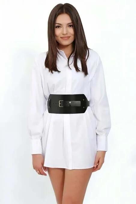 Black faux leather wide waist cinch belt with gold-tone square buckle worn over white shirt dress