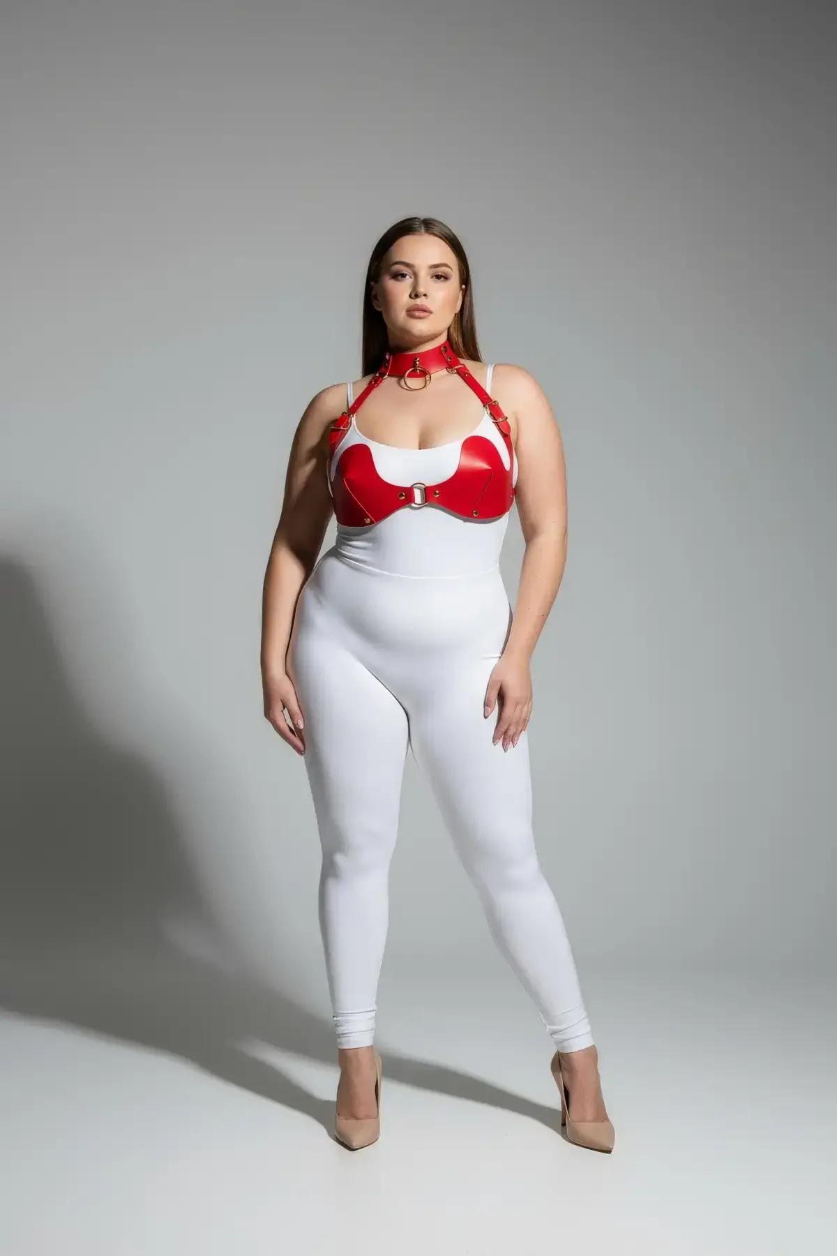 Red faux leather bra-cup chest harness with gold O-ring hardware and integrated choker band, front view