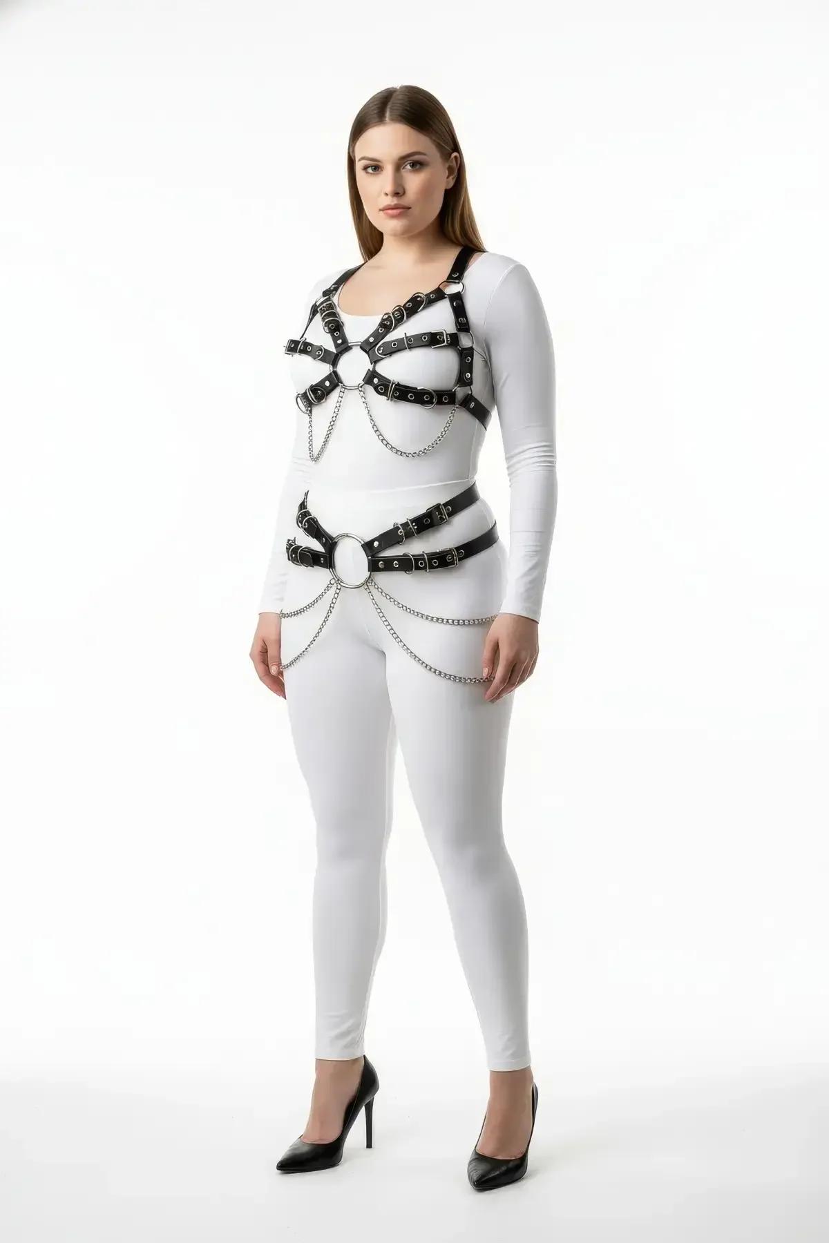 Black faux leather cage body harness with dual O-rings and silver draping chains worn over white top