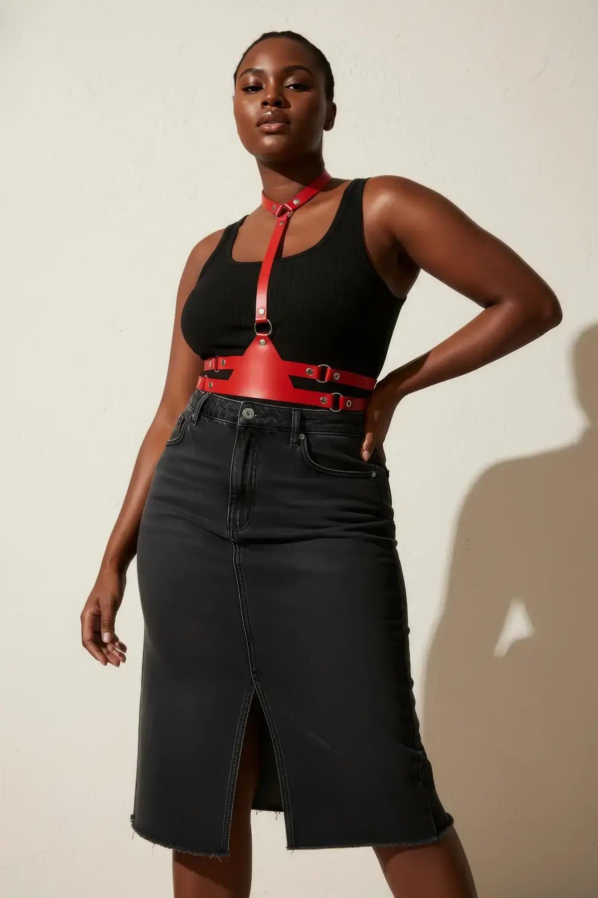 Red faux leather chest harness with choker collar, gunmetal O-ring front strap, and wide adjustable waist band worn over blac