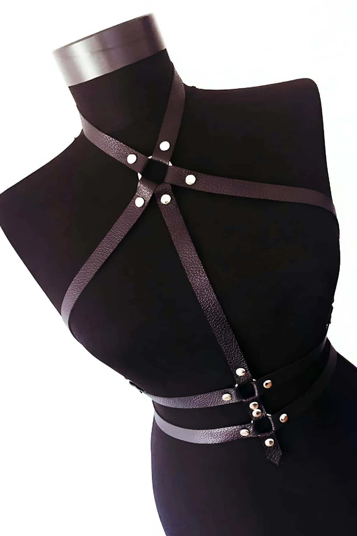 black faux leather chest harness with crossed straps silver rivets collar band and O-ring waist front view on mannequin