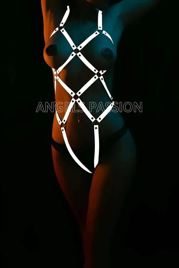 White reflective full body harness with diamond geometric strap pattern and metal junction hardware on dark background