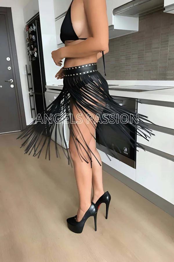 Black faux leather fringe waist belt with silver stud trim, long strands reaching mid-thigh, worn over black bikini bottoms