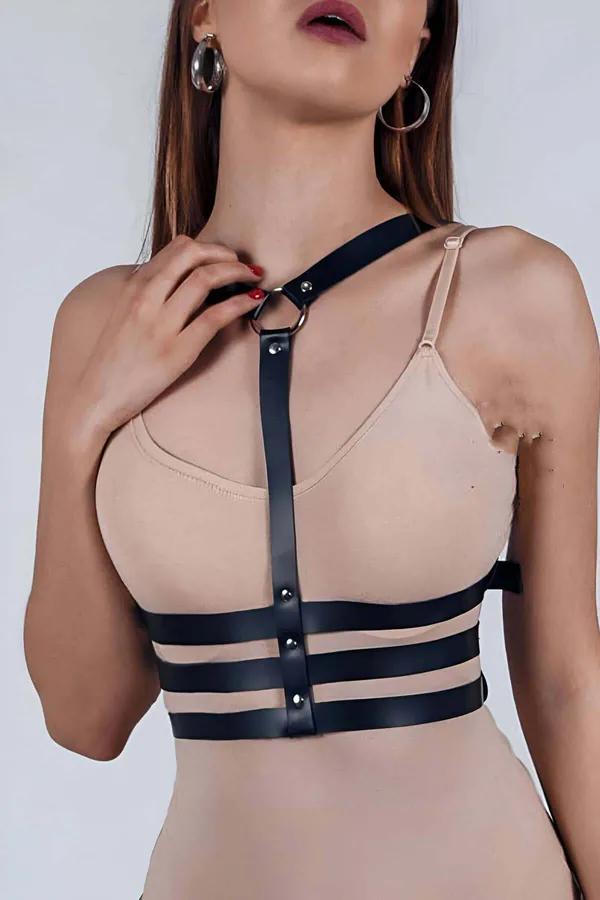 Black faux leather chest harness with triple underbust straps and silver O-ring on female model