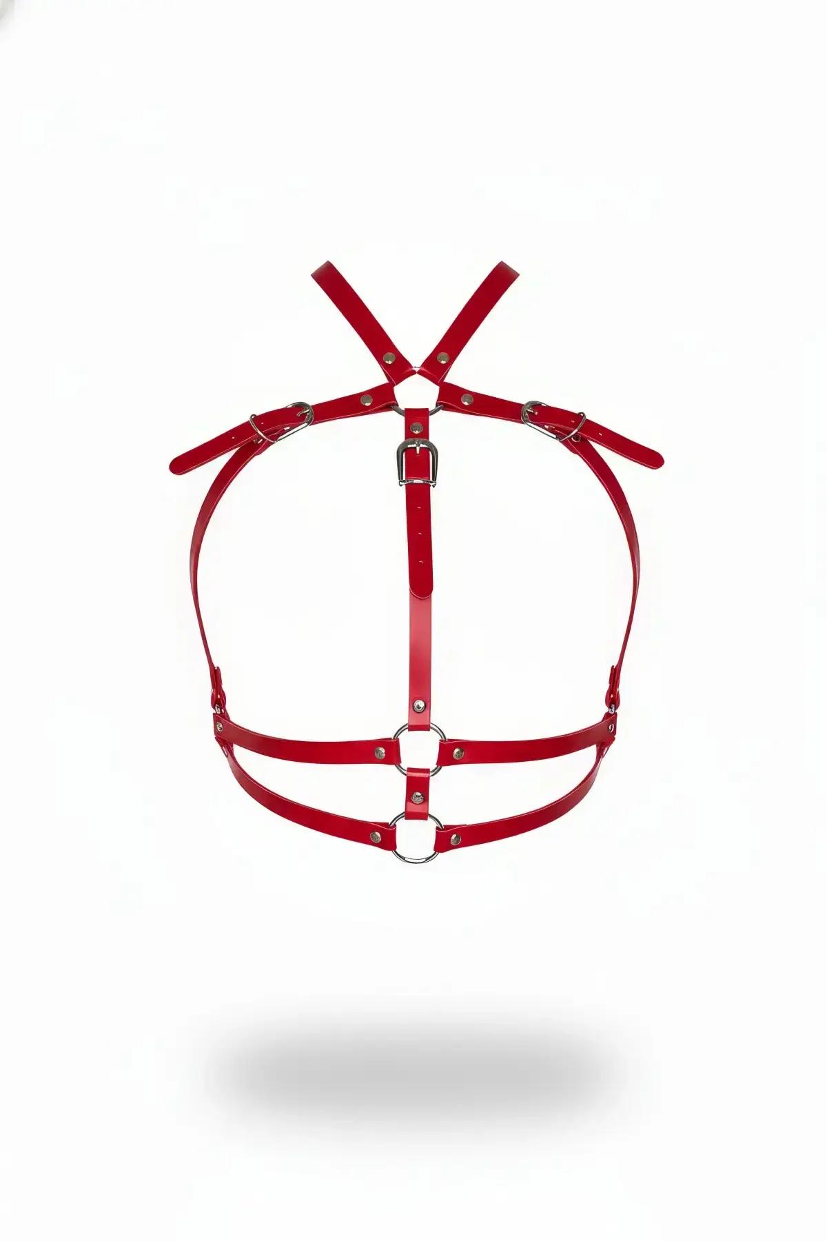 Red faux leather chest harness with dual silver O-rings and X-cross shoulder straps, front view on white background