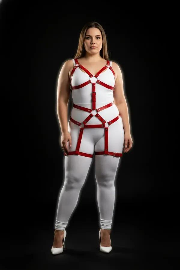 red faux leather full body harness with silver O-rings chest cage waist panel and thigh bands worn over white bodysuit