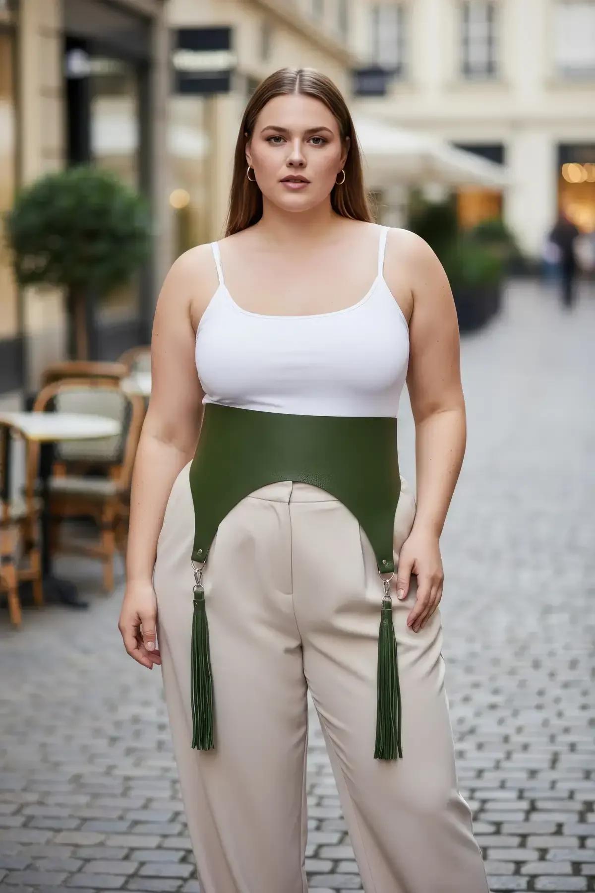 olive green wide faux leather waist harness with detachable silver clip fringe tassels worn over white tank top