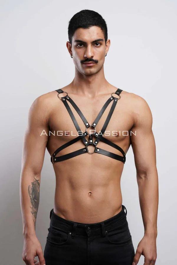 Black faux leather strappy O-ring chest harness on male model, silver hardware geometric strap design